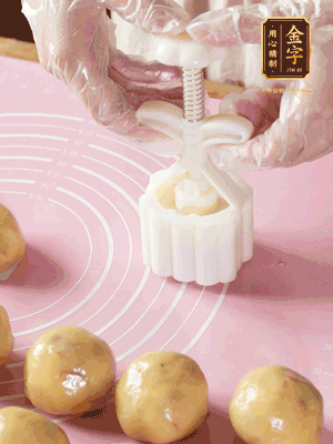 收緊虎口搓圓，裹上一層面粉，放入模具壓一壓